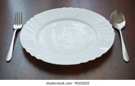 Silverware and plate on table