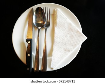 Silverware Stainless Utensil Cutlery On White Round Circle Dish With Triangle White Tissue Napkin For Dinner