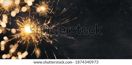 Silvester background banner panorama long- firework and sparklers on dark black night texture, with space for text
