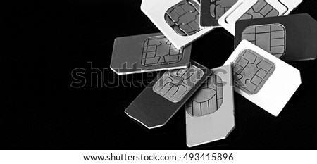 Sim card and micro simcard for mobile phone closeup on black background