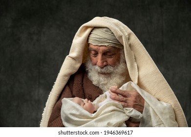 Simeon holding Baby Jesus in his arms against a dark background
