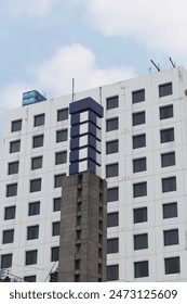 a simetrical building with a building on the background