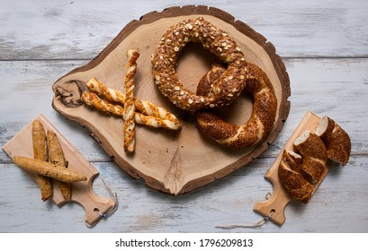 Simit Bagel On White Wooden Table And A Wood Log. Delicious Turkish Breakfast Concept.