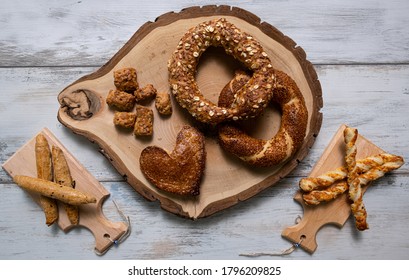 Simit Bagel On White Wooden Table And A Wood Log. Delicious Turkish Breakfast Concept.