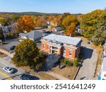 Simon Fairfield Public Library aerial view in fall with fall foliage at 290 Main Street in East Douglas village, town of Douglas, Massachusetts MA, USA. 