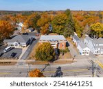 Simon Fairfield Public Library aerial view in fall with fall foliage at 290 Main Street in East Douglas village, town of Douglas, Massachusetts MA, USA. 