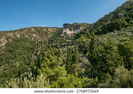 Simonos Petra Monastery, an architectural marvel perched atop a 230-meter rock. The fortress-like structure overlooks the Aegean Sea in the Monastic State of Mount Athos, Greece