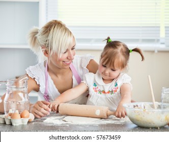 Simper mother and child baking cookies in the kitchen - Shutterstock ID 57673459