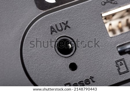 Simple 1 8 inch small jack cable connector aux input on an audio device, portable speaker, radio object macro, detail, extreme closeup. Sound, music, auxiliary cable input concept, nobody, no people