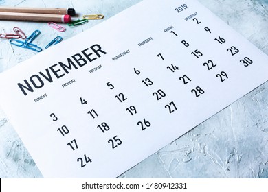 Simple 2019 November monthly calendar on table with office supplies