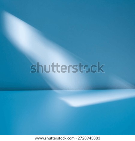 Simple abstract light blue background for product presentation with light beam on wall. Winter background.