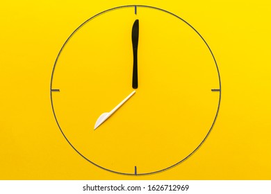 a simple abstract painted clock made of plastic fork and knife, creative idea of zero waste concept
