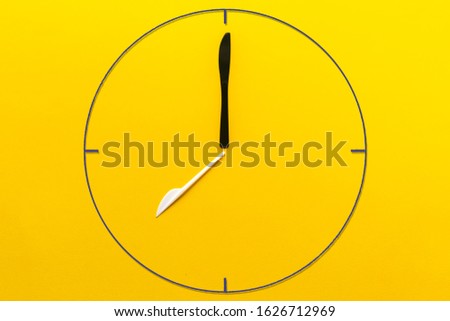 a simple abstract painted clock made of plastic fork and knife, creative idea of zero waste concept