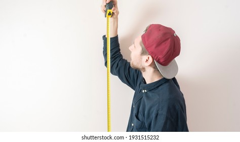 Simple Adult Teenager Male Person With A Roll Tape Measure The Height Against The Wall