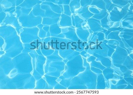 simple background of the blue water of the pool with light reflections and no people