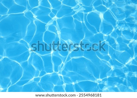 Simple background of the turquoise blue pool water with light reflections and no other people