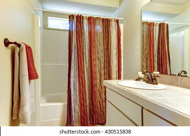 Simple Bathroom With Red And Browns Colors In Shower Curtain.