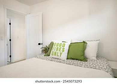 Simple bedroom in white with colourful pillows and throw blanket in green and yellow twin beds and queen sized bed with headboard and minimal decor hardwood vinyl plank flooring bedside table bright - Powered by Shutterstock