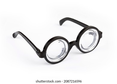 Simple big thick funny quirky nerd geek glasses, object isolated on white background, shadow. Stylish party props, humor fashion accessories, bad eyesight, eye wear props abstract concept, nobody