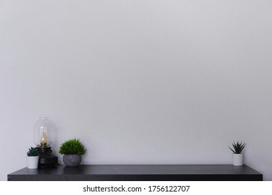 A Simple Black Desk With Succulents And An Edison Lamp Against A White Wall. A Clean Productive Workspace To Study, Journal, Work. Room For Text. Scandinavian Style.