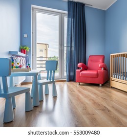 Simple Blue Baby Room With Cot, Armchair, Balcony, Window, Small Table And Chairs 