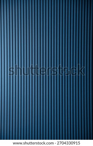 A simple blue background with vertical lines and copy-space available for adding text or other graphics to the backdrop. Great for design or presentation projects. Copy ad text space