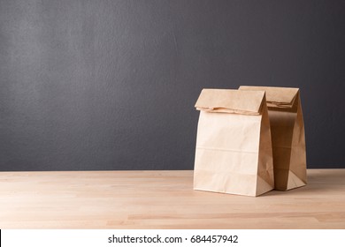 Simple Brown Paper Bag For Lunch Or Food On Wooden Table With Copy Space