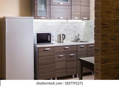 Simple, Cheap Kitchen In A Rented Apartment. Microwave, Kettle And Fridge. Wide Angle