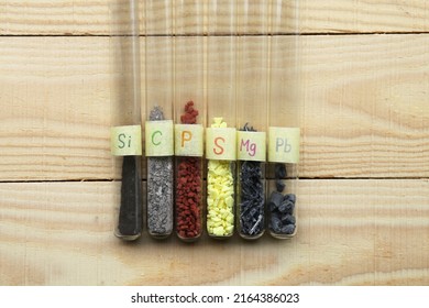 Simple chemicals, non-metals and metals in test tubes: amorphous silicon, gray carbon, crystalline red phosphorus, yellow crystalline sulfur, magnesium, heavy lead.