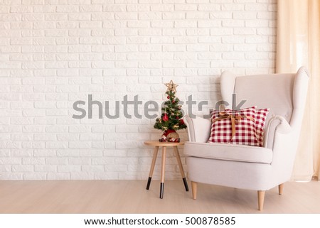 Simple Christmas living room with armchair and small Christmas tree