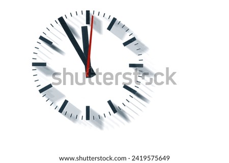 a simple clock or dial which was originally a german train station clock, the hands indicating five to twelve and indicating it is high time