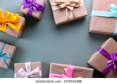 Simple composition with multiple presents wrapped in hand made blank craft paper gift wrap, pastel satin bow. Simple giftbox, wrapping, giftwrap, silk ribbon. Pink background, close up, copy space.
