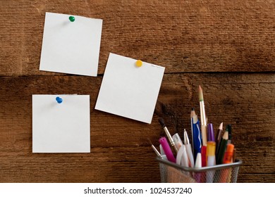 Simple composition with pens and notes closeup on the wooden backing natural