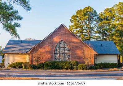Simple country church in Georgia, with trees in the background and the the left foreground; a cross is blended  in nicely with the "broken glass" window pattern.