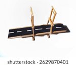 A simple drawbridge model made from popsicle sticks resembles a miniature highway on a white background.