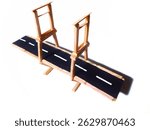 A simple drawbridge model made from popsicle sticks resembles a miniature highway on a white background.