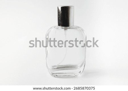 Simple and elegant empty perfume bottle standing upright on white background. Perfect for branding, mockups, cosmetic ads, or minimalist product presentations. Isolated on white. 