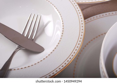 Simple and elegant golden decal design on classic white porcelain dishes