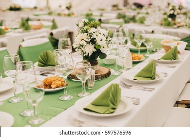 Simple and elegant wedding or festive table setting. Green and beach colors.