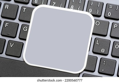 Simple Empty Blank Grey Square Commercial Logo Placeholder Card, Gray Sticker, Label Laying On A Modern Computer Keyboard, Object Closeup, Copy Space, Nobody No People. Technology Software Logo Mockup