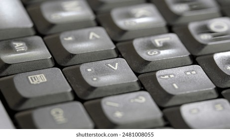 Simple generic laptop computer keyboard keys seen from up close at an angle, shallow depth of field, soft focus blur abstract background texture, backdrop, up close macro detail shot nobody, no people
