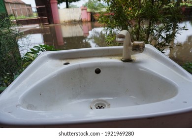 Simple Hand Washing Place Or Sink In Front Of The School And There Is A Pool Of Water.