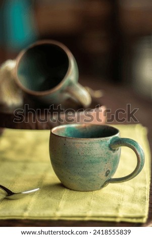 Similar – A painted ceramic milk jug next to an empty white cup