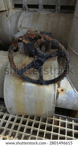 Simple image of a corroded handle valve with visible rust and surface damage.