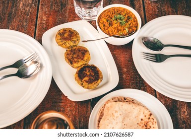 Simple Indian Vegetarian Home Food Served At A Table. Soya Keema Served With Roti Bread On A White Plate On A Wooden Table.