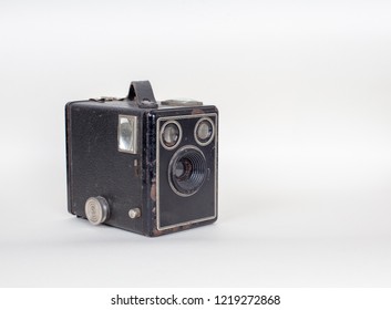 Simple and inexpensive Basic cardboard box camera with a simple meniscus lens isolated on white with shadow