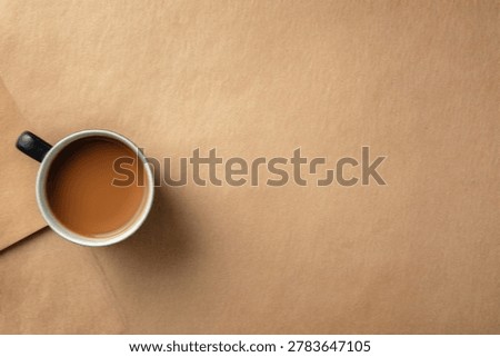 A simple, inviting image of a coffee mug viewed from directly above, placed on a neutral, textured surface.
