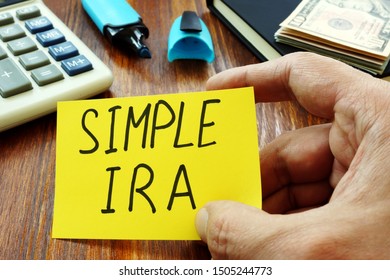 Simple IRA Retirement Plan In The Hands Of A Man.