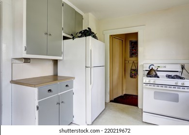 Simple Kitchen Interior With White Stove And Refrigerator In Old House