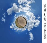 simple little tiny planet without buildings in blue sky with beautiful clouds. Transformation of spherical panorama 360 degrees. Spherical abstract aerial view. Curvature of space.